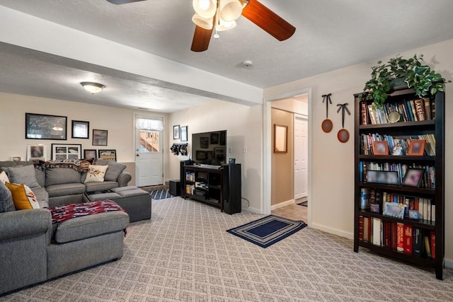 living area with a ceiling fan, carpet flooring, and baseboards