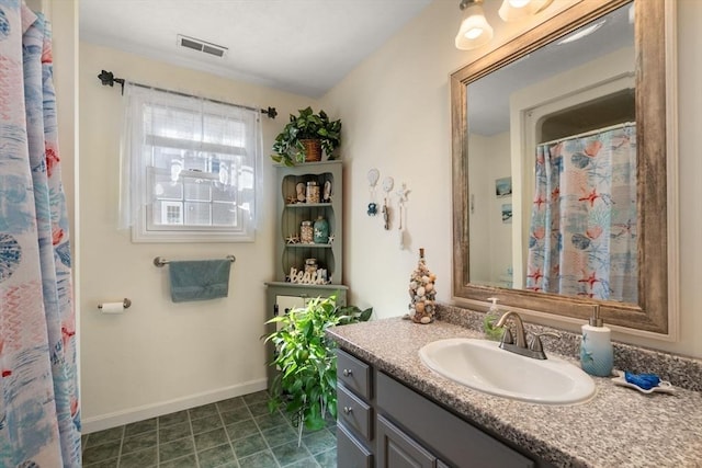 bathroom featuring a shower with curtain, visible vents, vanity, and baseboards