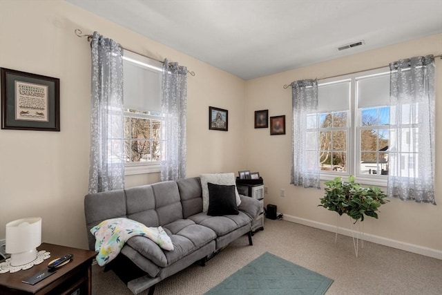 living room featuring carpet, visible vents, and baseboards