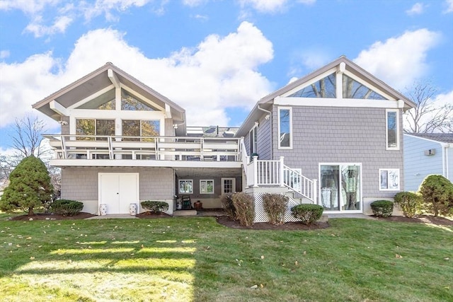 rear view of property featuring a deck and a lawn