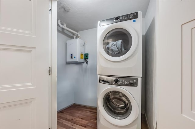 510 Dorchester Ave Unit 2R, Boston, MA 02127 - laundry room featuring estacked washer and dryer, wood finished floors, tankless water heater, and baseboards
