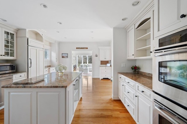 kitchen featuring white cabinetry, open shelves, stainless steel appliances, and light wood-type flooring