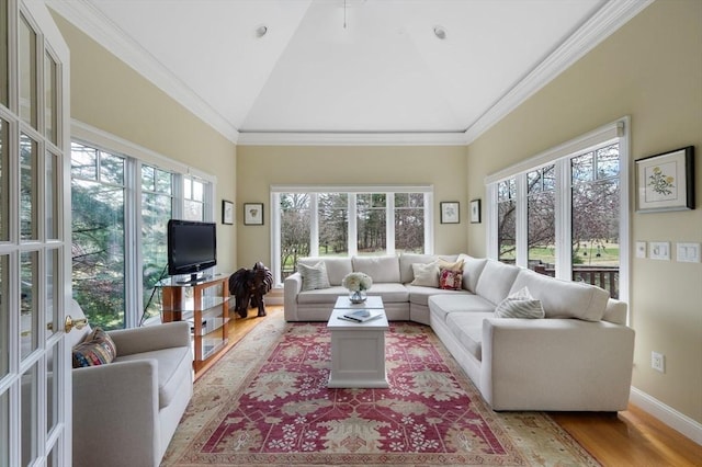 living room with high vaulted ceiling, baseboards, crown molding, and wood finished floors