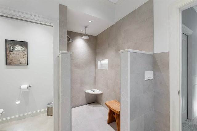 bathroom with walk in shower, toilet, tile walls, and tile patterned floors