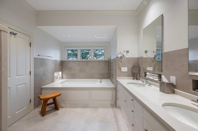 bathroom featuring a bath, tile walls, a sink, and double vanity