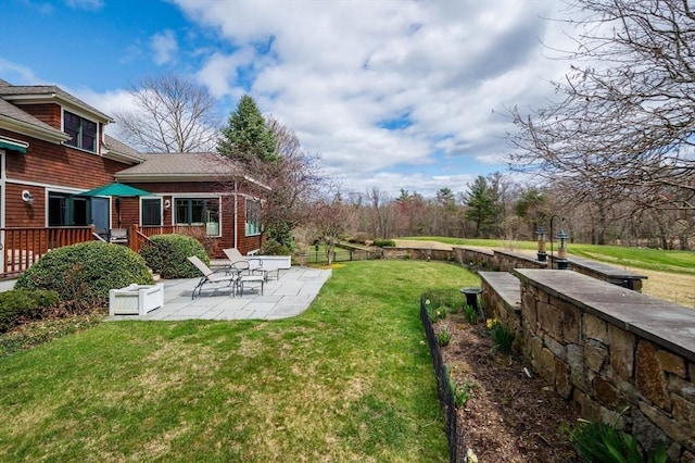 view of yard with a patio area and a deck