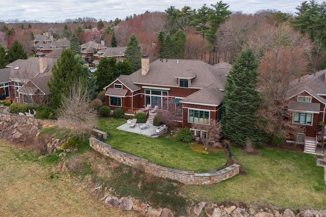 exterior space with a yard, a patio, and a chimney