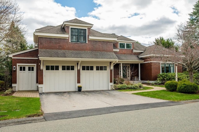 view of front facade with an attached garage and aphalt driveway