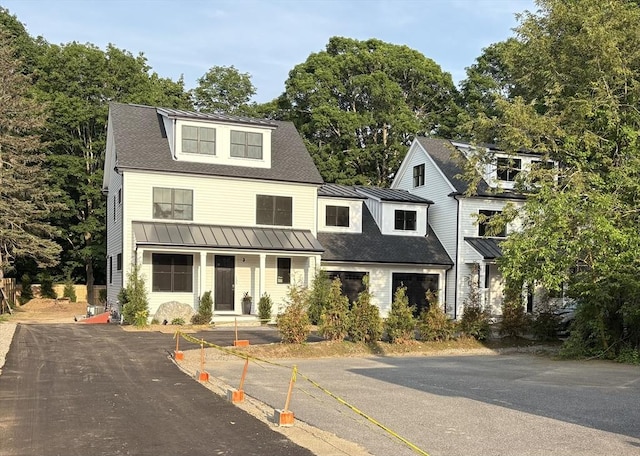 132 Hillside Ave Unit 132, Needham, MA 02494 - view of front facade featuring a standing seam roof, a metal roof, and view of wooded area