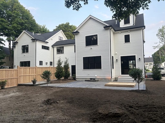 132 Hillside Ave Unit 132, Needham, MA 02494 - back of house featuring entry steps, a patio, and roof with shingles