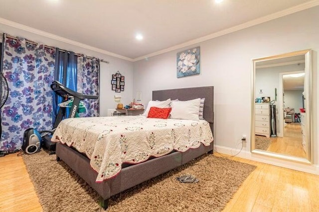 bedroom featuring crown molding and hardwood / wood-style floors