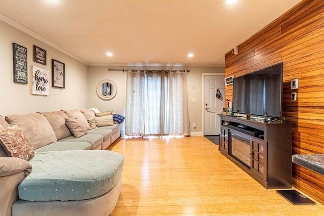 living room featuring ornamental molding and light hardwood / wood-style floors