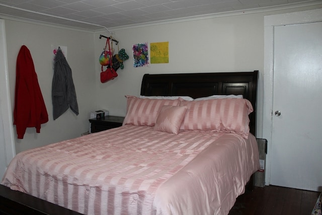 bedroom with dark hardwood / wood-style flooring