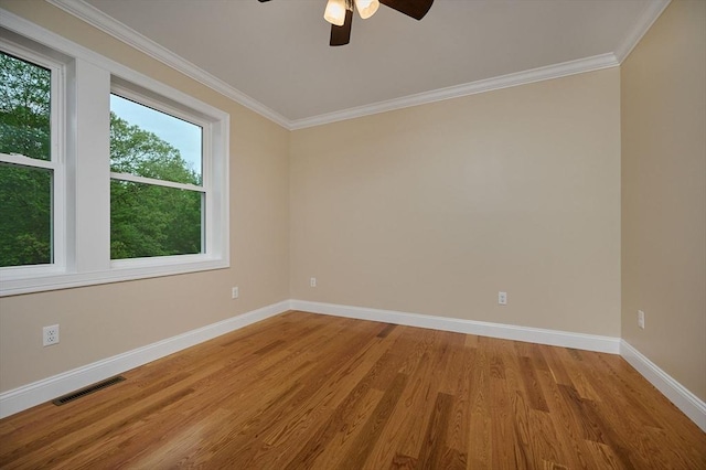 unfurnished room featuring wood finished floors, baseboards, a ceiling fan, and crown molding