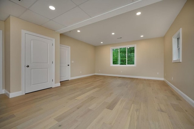 empty room with baseboards, light wood-type flooring, and recessed lighting