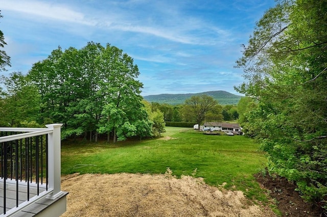 view of grassy yard featuring a mountain view