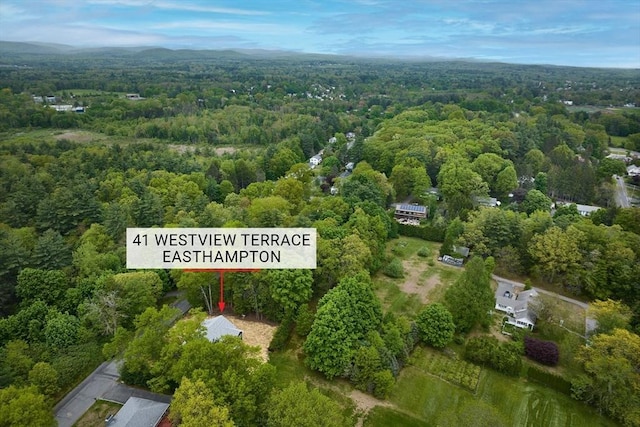 aerial view of property's location featuring a heavily wooded area