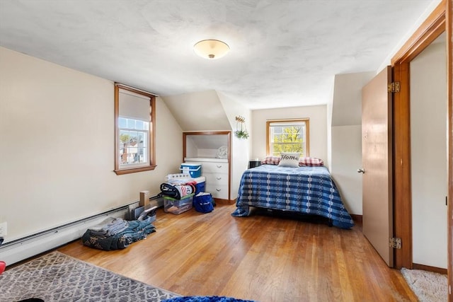 bedroom featuring vaulted ceiling and wood finished floors
