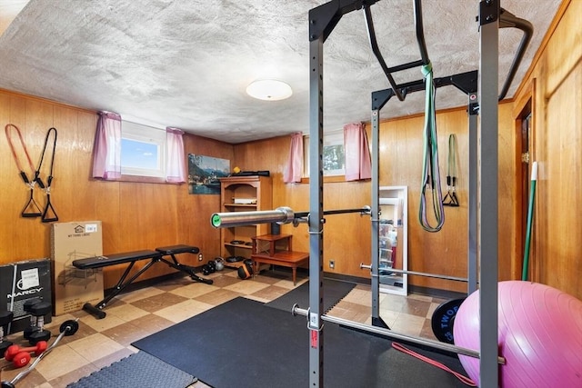 workout room with wooden walls and tile patterned floors