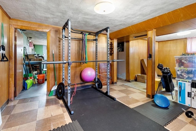 workout area with wooden walls and tile patterned floors