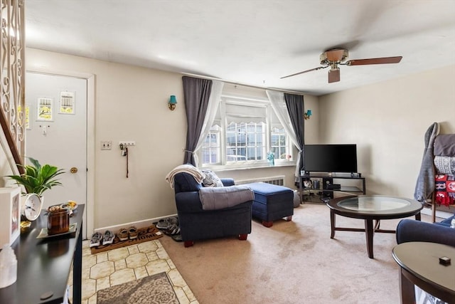 carpeted living area featuring ceiling fan