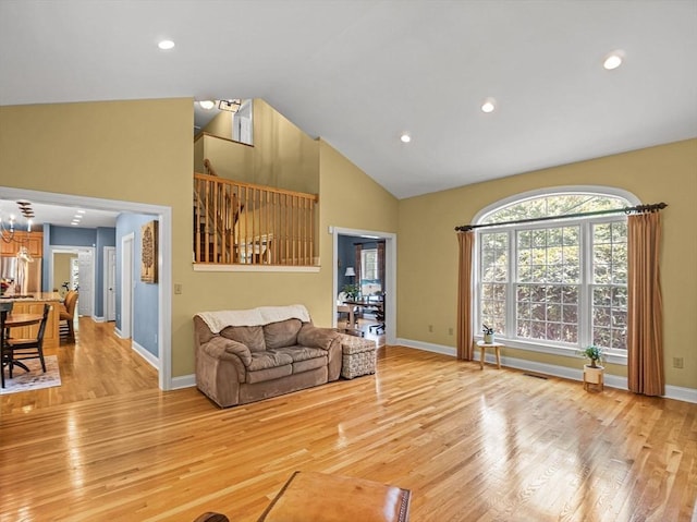 455 Brockelman Rd, Lancaster, MA 01523 - living room featuring light wood-type flooring, high vaulted ceiling, a chandelier, and recessed lighting