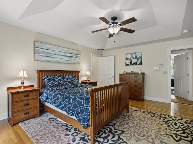 455 Brockelman Rd, Lancaster, MA 01523 - bedroom with wood finished floors, a tray ceiling, and a ceiling fan