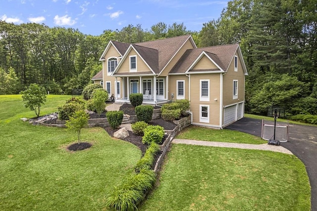 455 Brockelman Rd, Lancaster, MA 01523 - view of front of property with covered porch, driveway, an attached garage, and a front yard