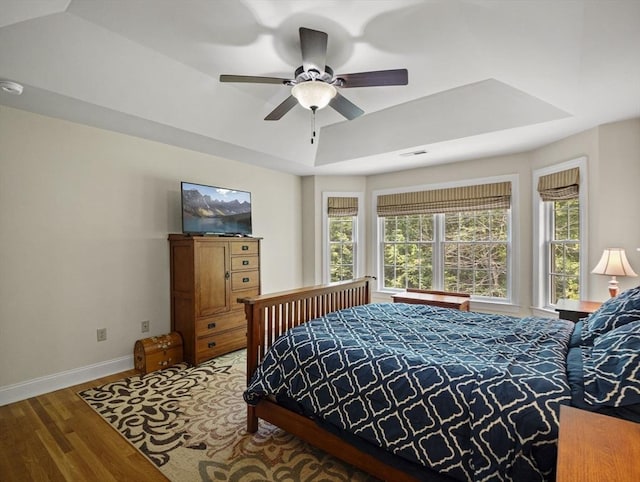 455 Brockelman Rd, Lancaster, MA 01523 - bedroom featuring multiple windows, wood finished floors, a raised ceiling, and ceiling fan