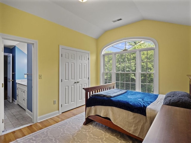 455 Brockelman Rd, Lancaster, MA 01523 - bedroom featuring lofted ceiling, light wood-style floors, ensuite bathroom, and a closet