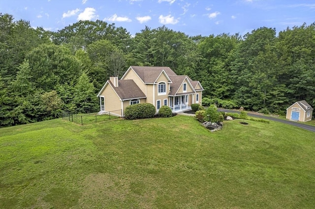 455 Brockelman Rd, Lancaster, MA 01523 - view of front of property with a forest view, an outbuilding, and a chimney
