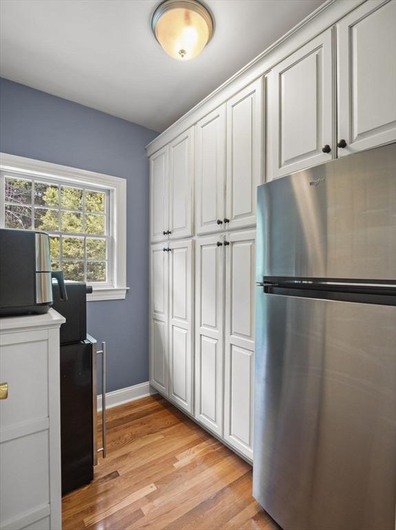 455 Brockelman Rd, Lancaster, MA 01523 - kitchen with freestanding refrigerator, light wood finished floors, and white cabinetry