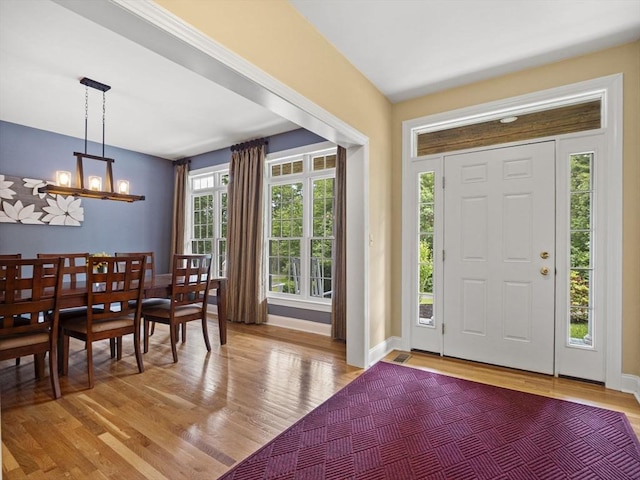 455 Brockelman Rd, Lancaster, MA 01523 - entrance foyer with light wood finished floors and a chandelier