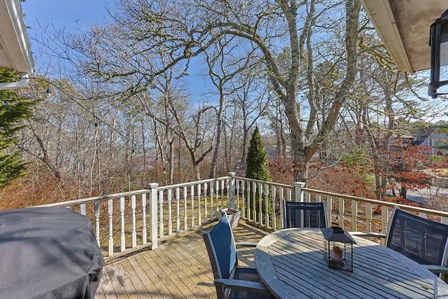 wooden terrace featuring outdoor dining area and area for grilling