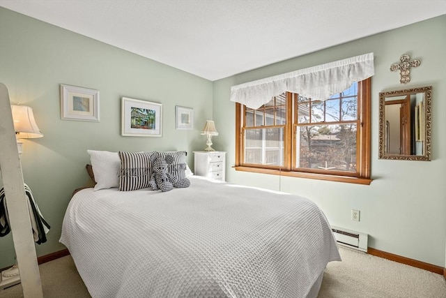 carpeted bedroom featuring a baseboard radiator and baseboards