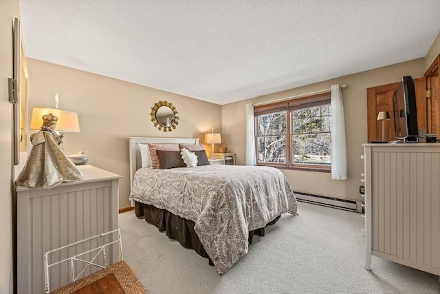 bedroom featuring a baseboard heating unit, a textured ceiling, and light colored carpet