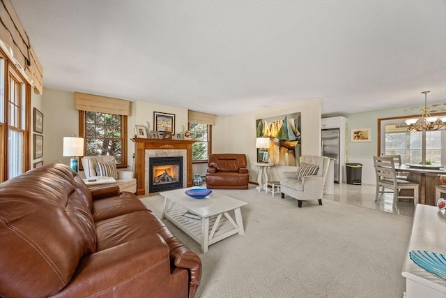 living room with a fireplace with flush hearth and a chandelier