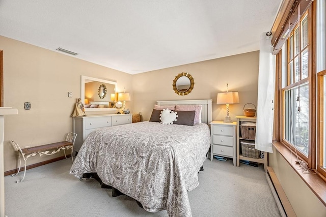 bedroom featuring a baseboard radiator, light colored carpet, visible vents, and baseboards