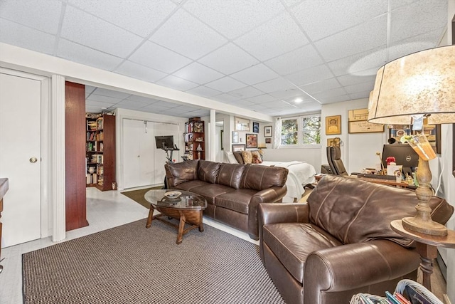 living area with a paneled ceiling