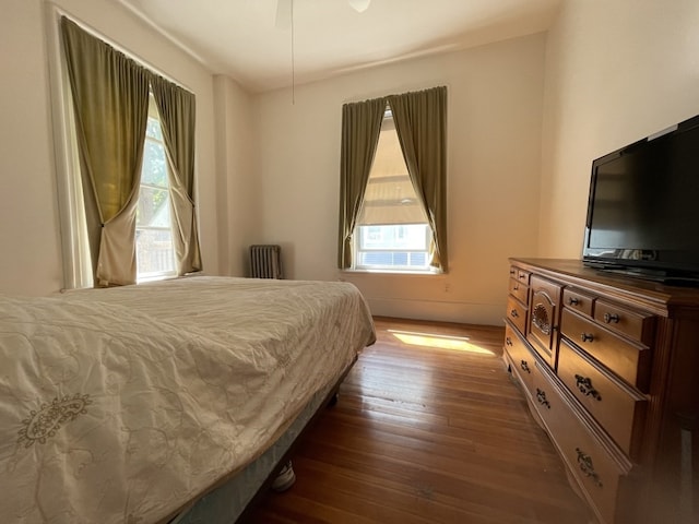 bedroom with ceiling fan and dark hardwood / wood-style floors