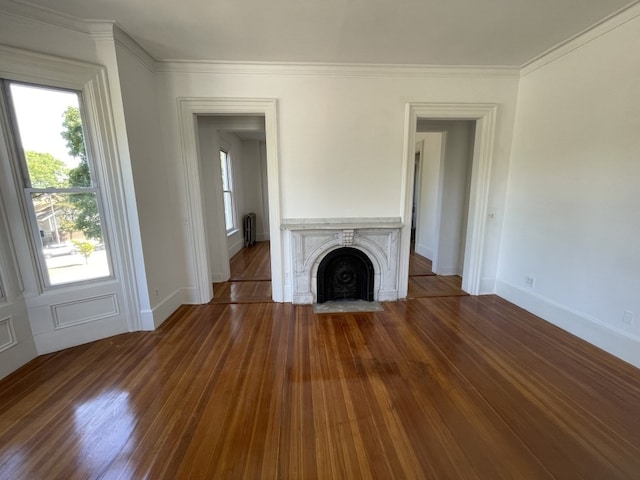 unfurnished living room with radiator, crown molding, and dark hardwood / wood-style flooring