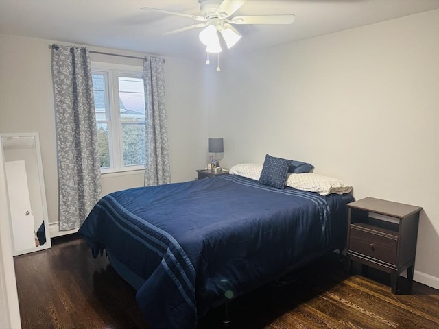 bedroom featuring wood finished floors, baseboards, and a ceiling fan