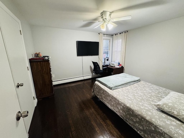 bedroom featuring baseboard heating, wood finished floors, and a ceiling fan