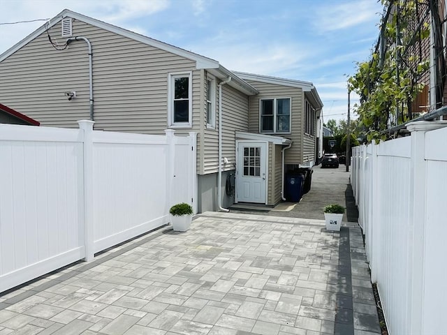 view of side of home with a patio and a fenced backyard