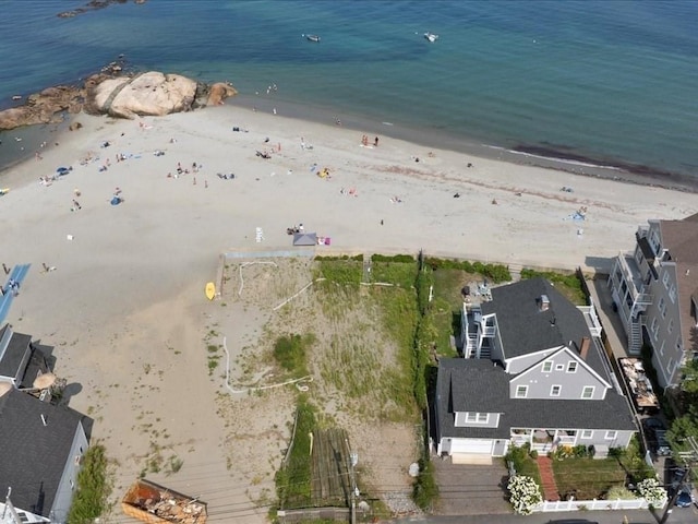 bird's eye view featuring a water view and a beach view