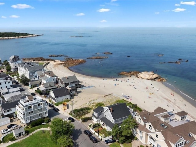 birds eye view of property with a view of the beach and a water view