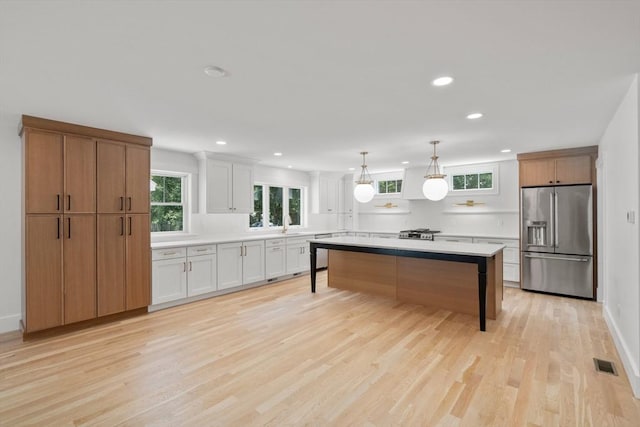 14 Norman Ave, Newburyport, MA 01950 - kitchen with appliances with stainless steel finishes, recessed lighting, light countertops, a kitchen bar, and light wood-style floors