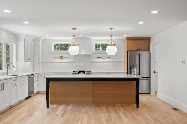 14 Norman Ave, Newburyport, MA 01950 - kitchen with appliances with stainless steel finishes, light wood finished floors, a center island, healthy amount of natural light, and recessed lighting