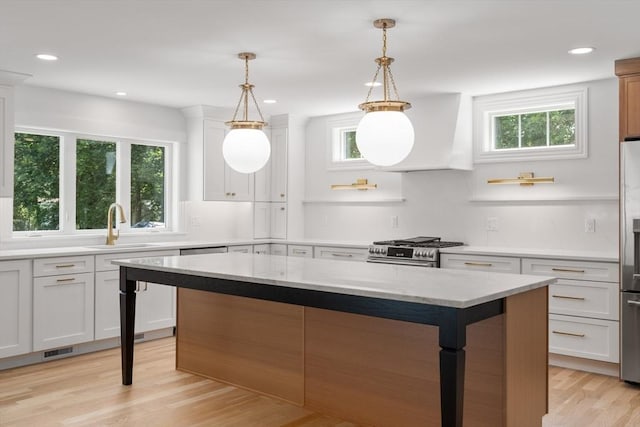 14 Norman Ave, Newburyport, MA 01950 - kitchen with appliances with stainless steel finishes, healthy amount of natural light, light wood finished floors, a center island, and recessed lighting