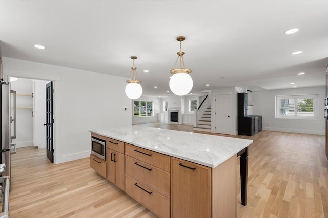 14 Norman Ave, Newburyport, MA 01950 - kitchen featuring stainless steel microwave, open floor plan, light wood-type flooring, plenty of natural light, and recessed lighting